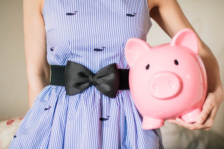 woman holding a piggy bank