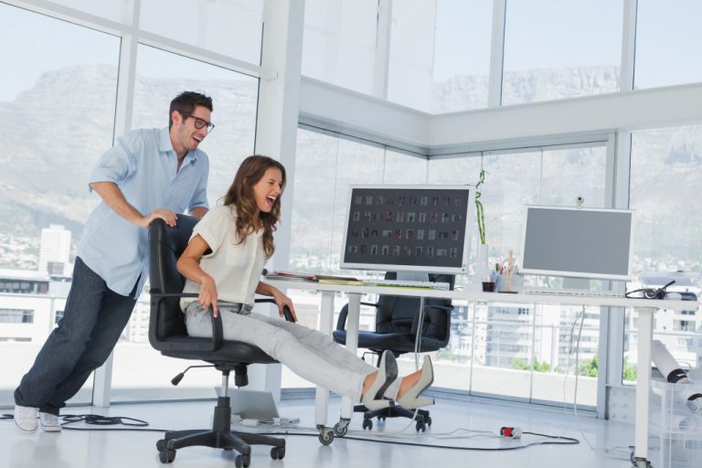 Designers having fun with a swivel chair in their office