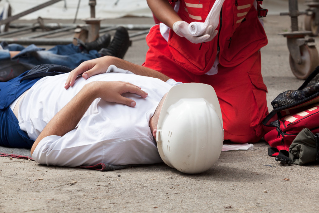 Paramedic providing first aid to an injured employee.
