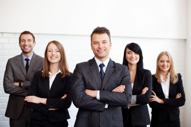 A group of business employees smiling to the camera